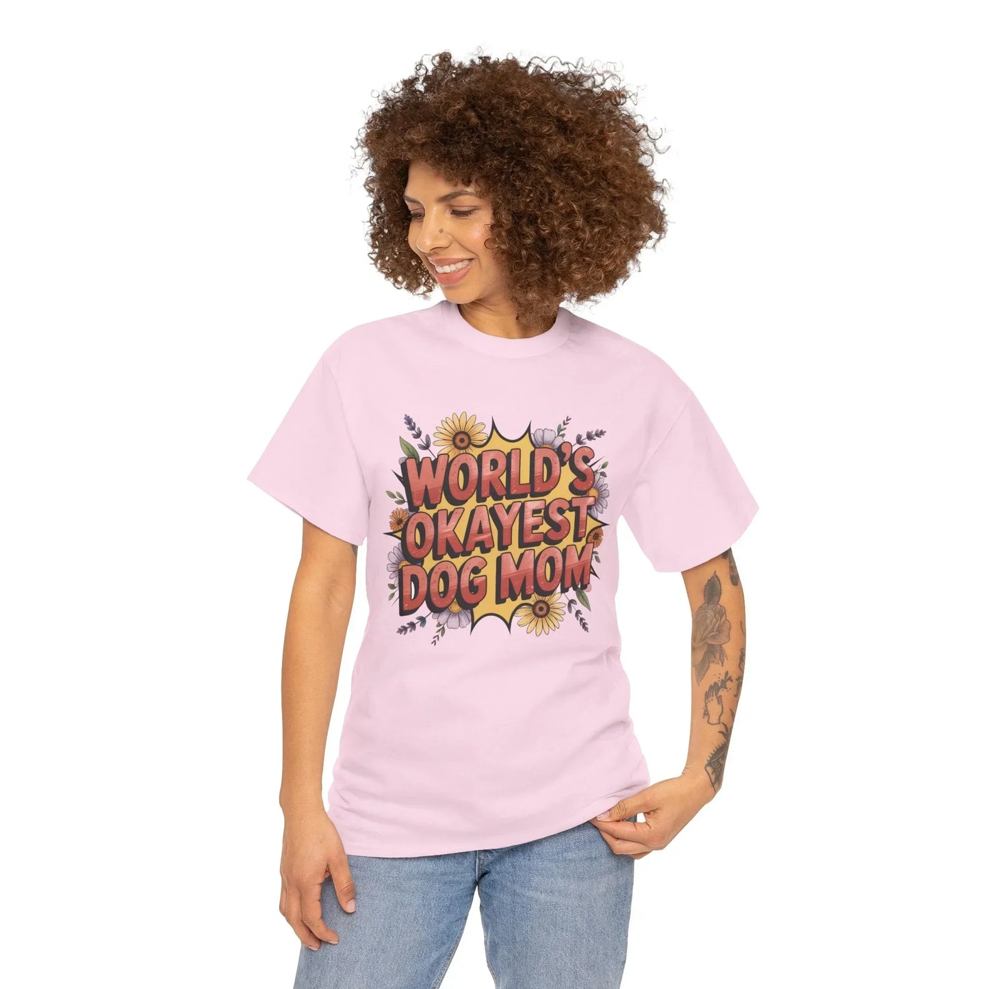 Woman wearing a pink t-shirt with 'World's Okayest Dog Mom' floral print design