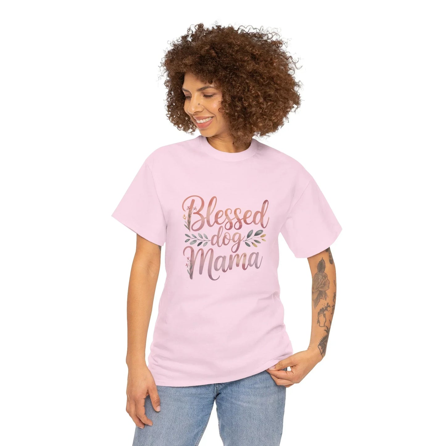 Smiling woman in pink Blessed Dog Mama t-shirt, casual outfit, tattooed arm