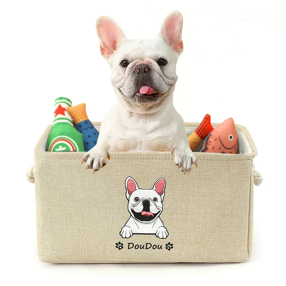 French bulldog in beige pet storage box with dog toys and cartoon dog print on front