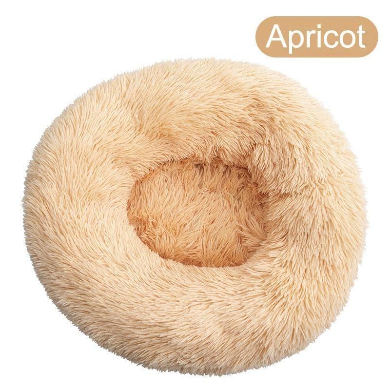Apricot round plush dog bed, soft donut shape, cozy pet bed for dogs.